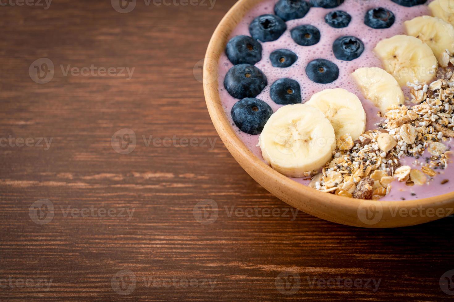 yogurt or yoghurt smoothie bowl with blue berry, banana and granola photo