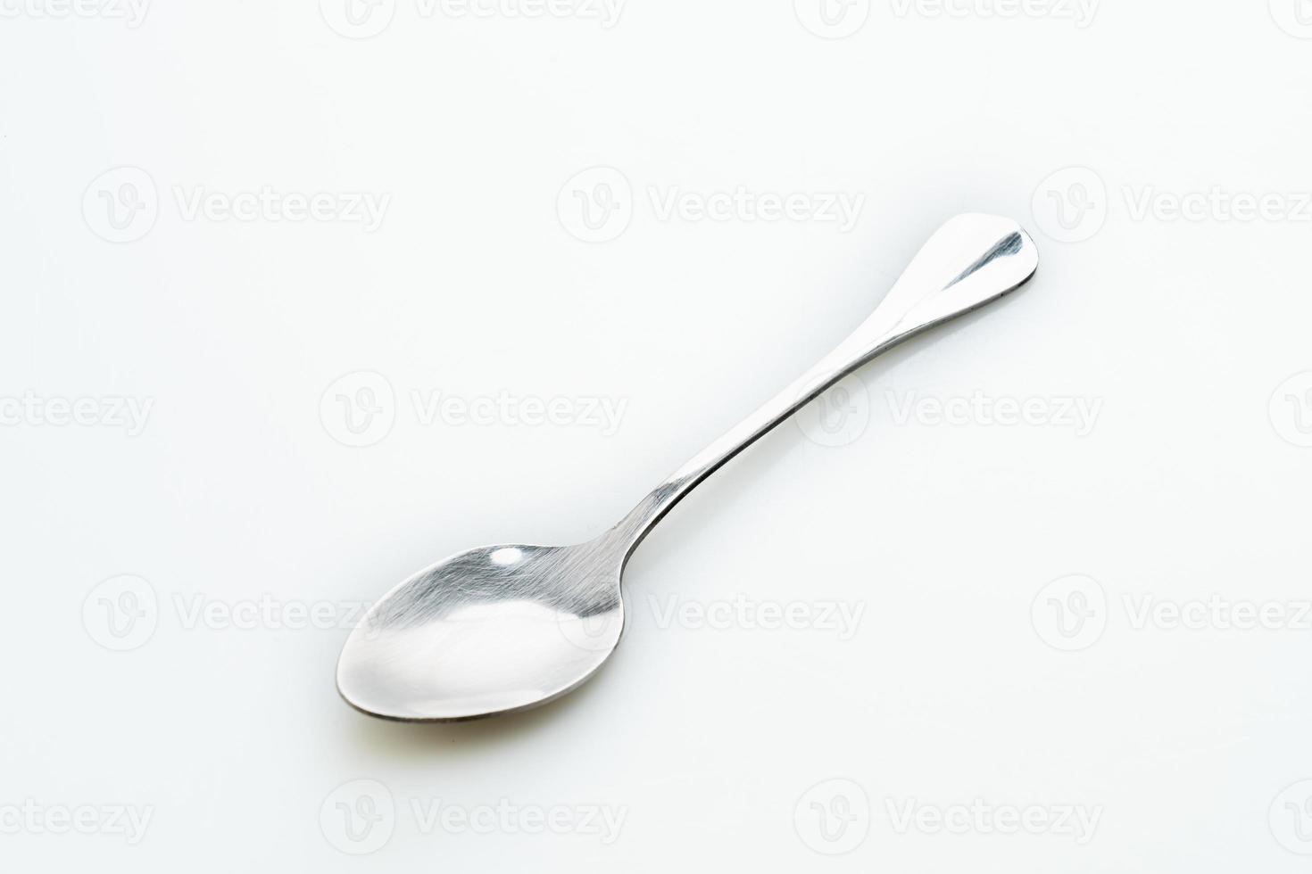 silver spoon on white background photo