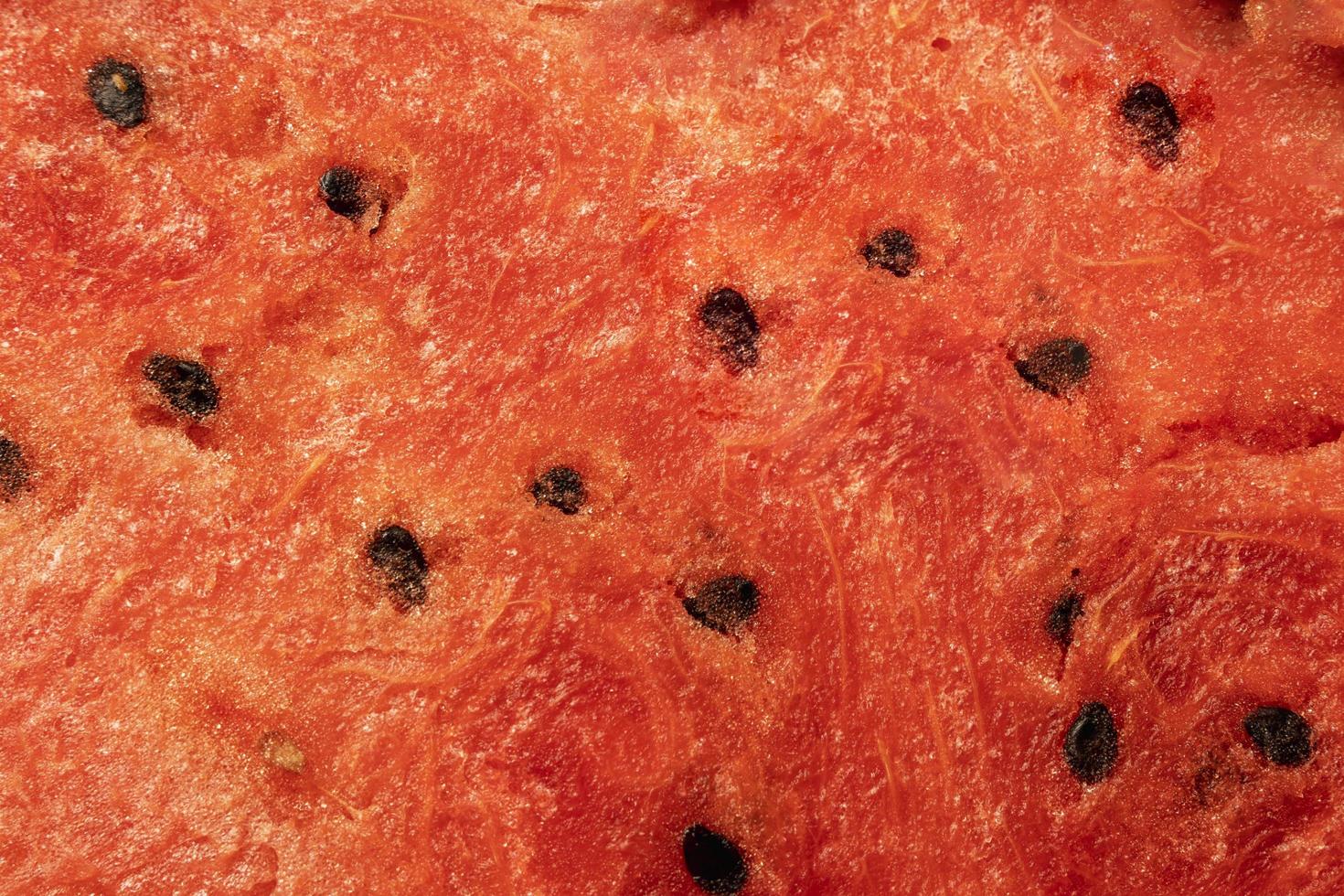 Watermelon background, juicy pulp and seeds, red background, watermelon slice texture photo