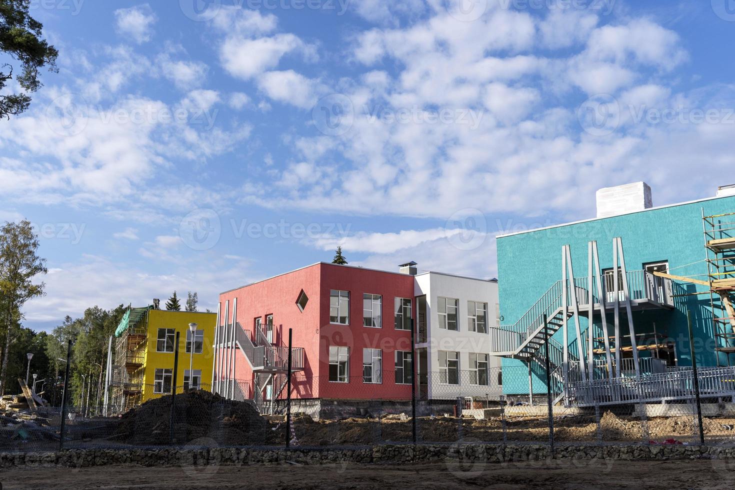 The progress of the construction of the kindergarten building. Colorful cheerful modern decoration of building facades photo