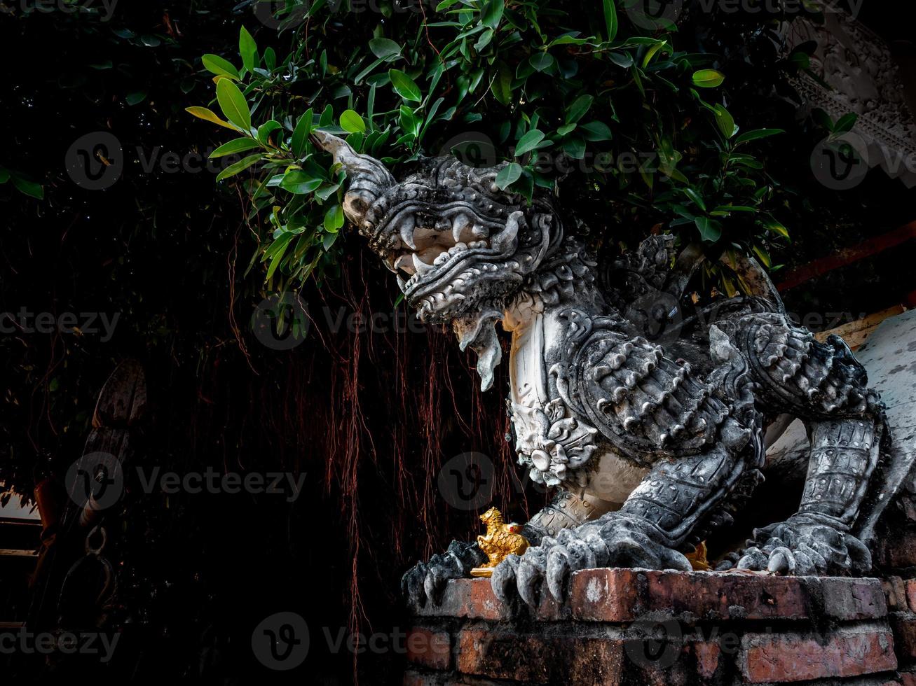 Ancient Himmapan Leo Statue Guarding the foot of the stairs up the temple hall photo