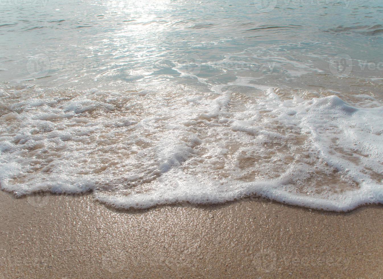 Bubble of Sea wave on sand photo