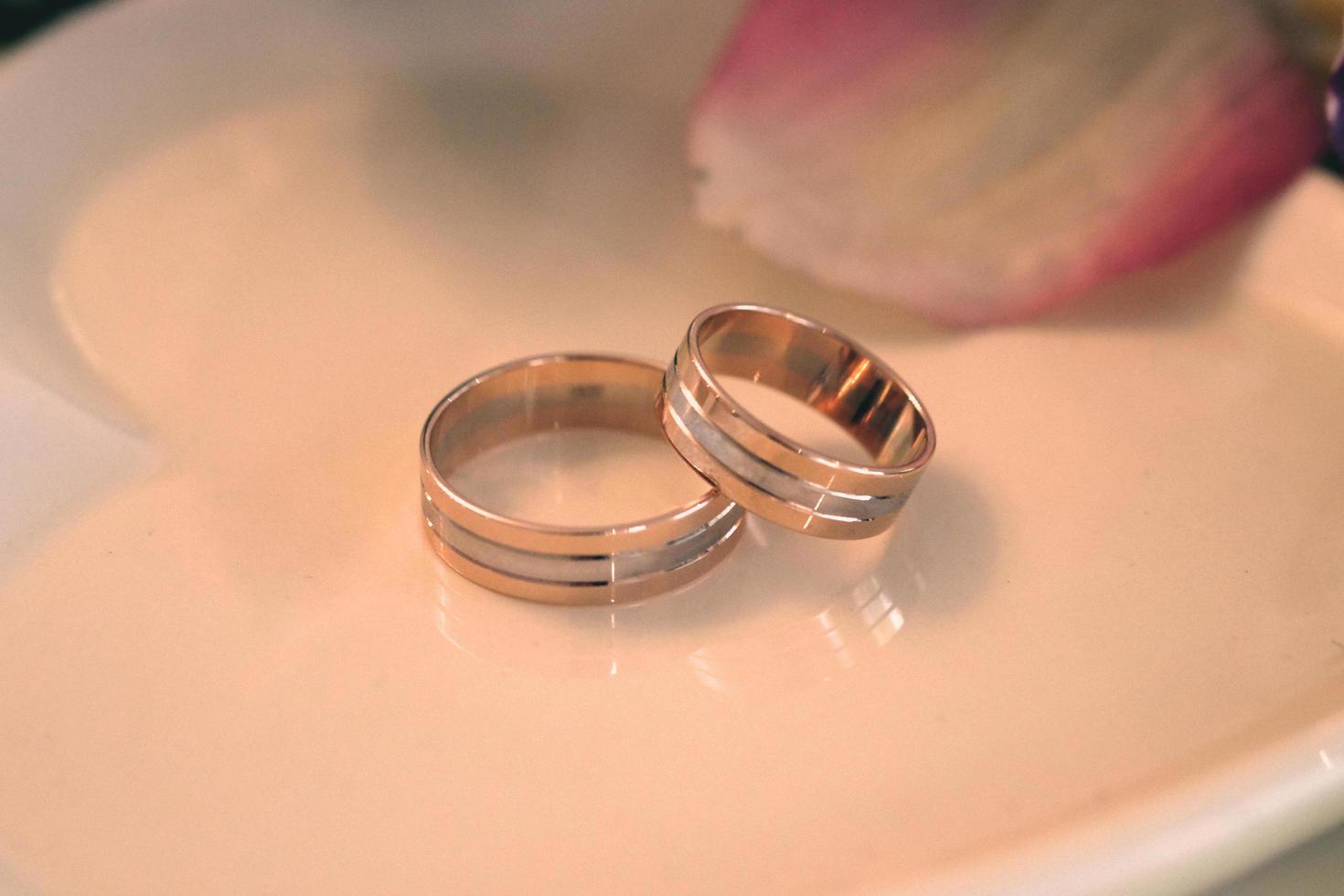 Wedding rings on a white saucer photo