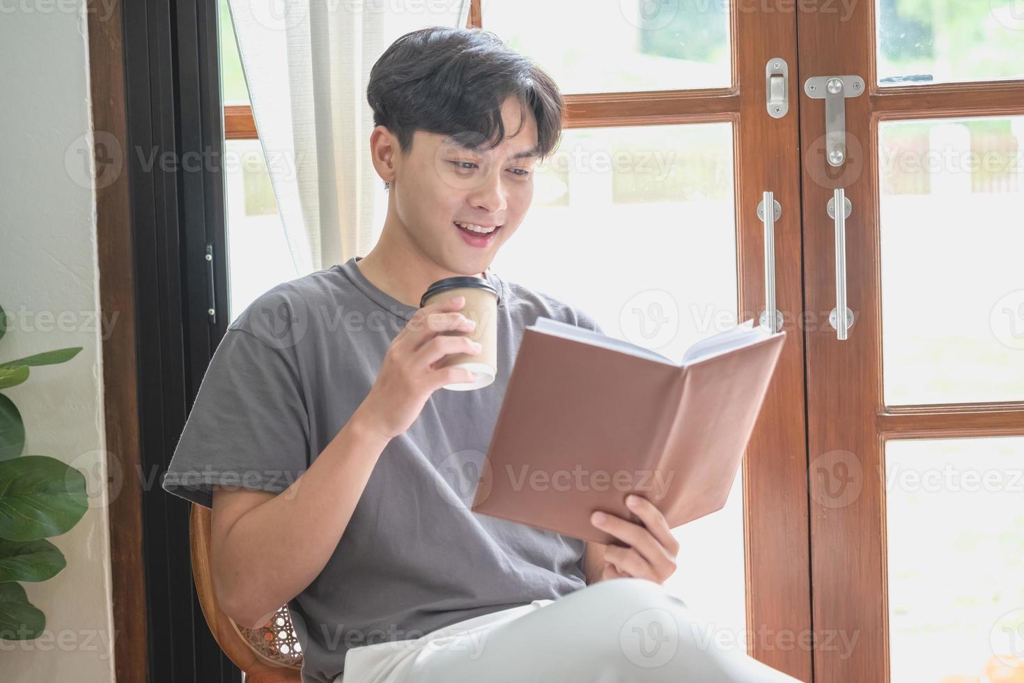 Portrait of a white man sitting inside the house reading and drinking coffee to relax on vacation. photo