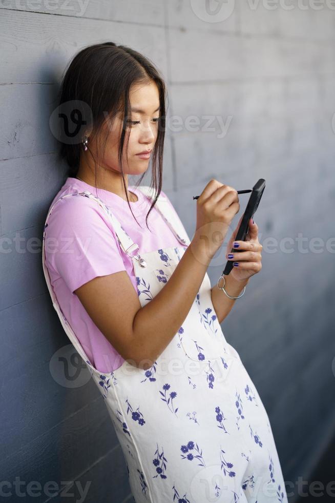 Asian woman browsing data on smartphone photo