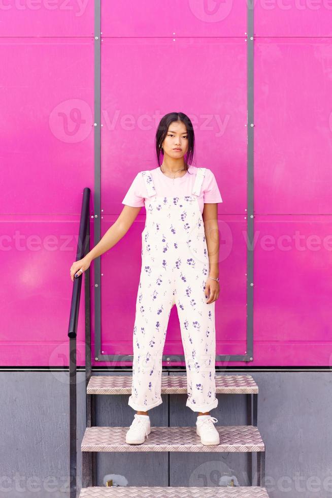 Asian female standing on stairs photo