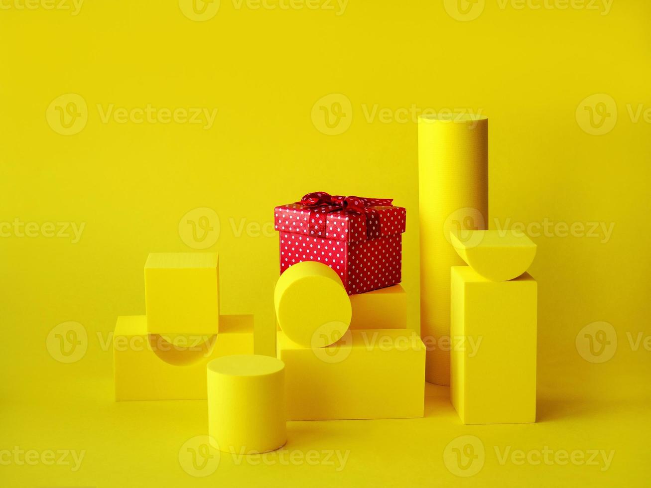 Composition with podiums for the presentation of products. Layout of the scene with yellow figures and a gift. Showcase photo