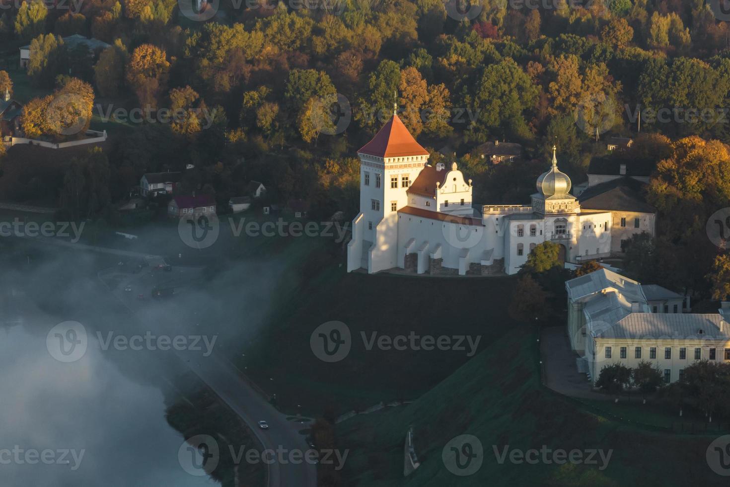 earlier foggy morning and aerial panoramic view on medieval castle and promenade overlooking the old city and historic buildings near wide river photo