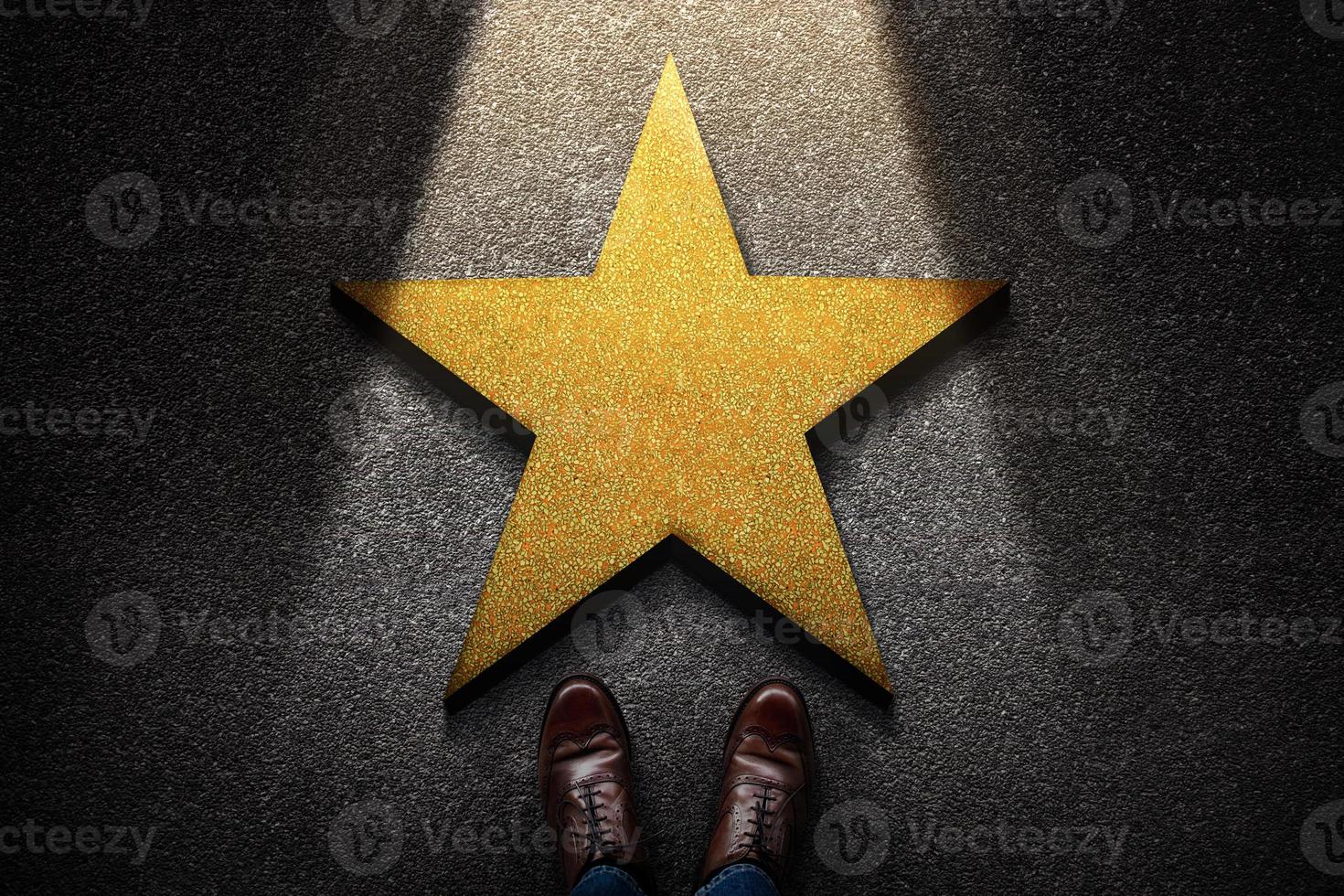 Success in Business or Personal Talent Concept. Top View of Business Person in Working Shoes Standing in front of a Golden Star. Light Shining on the Dark Cement Floor photo