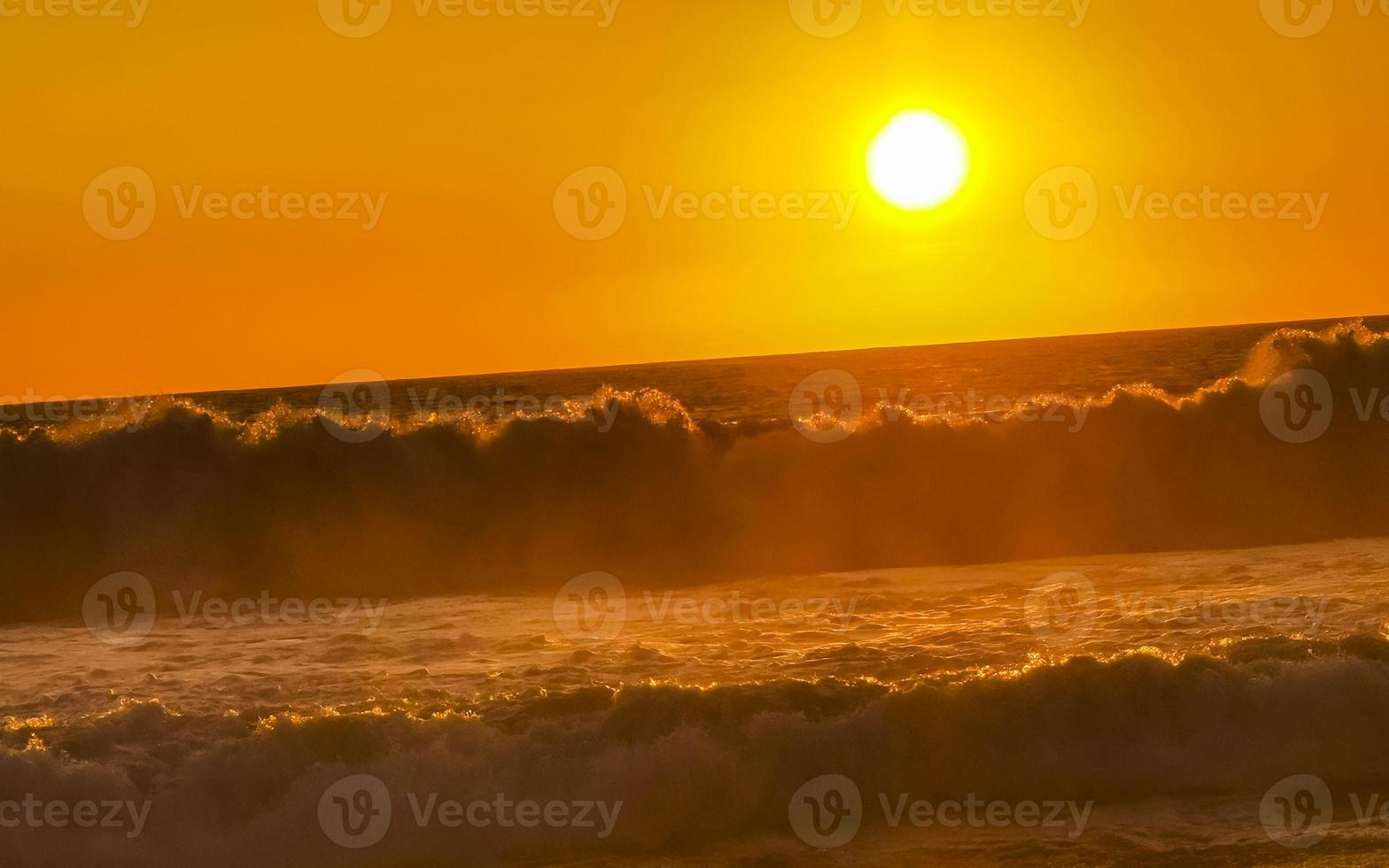 Colorful golden sunset big wave and beach Puerto Escondido Mexico. photo