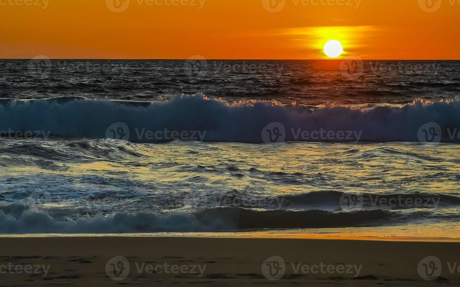 Colorful golden sunset big wave and beach Puerto Escondido Mexico. photo