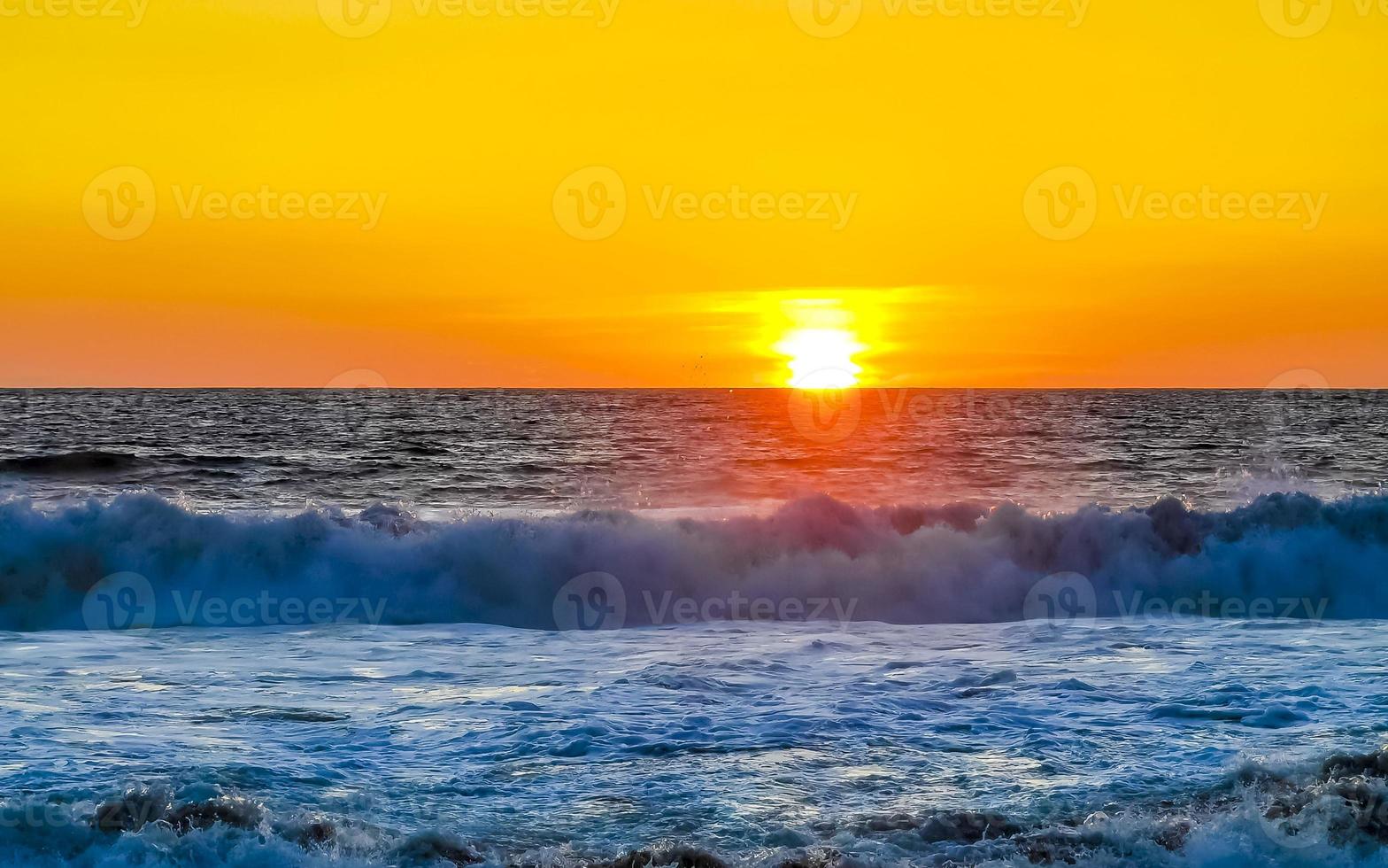 Colorful golden sunset big wave and beach Puerto Escondido Mexico. photo