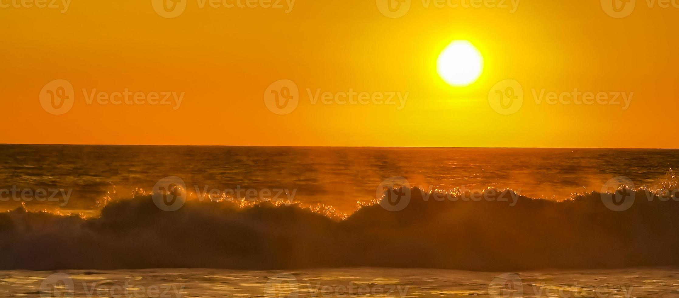 Colorful golden sunset big wave and beach Puerto Escondido Mexico. photo