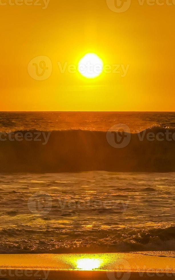 Colorful golden sunset big wave and beach Puerto Escondido Mexico. photo