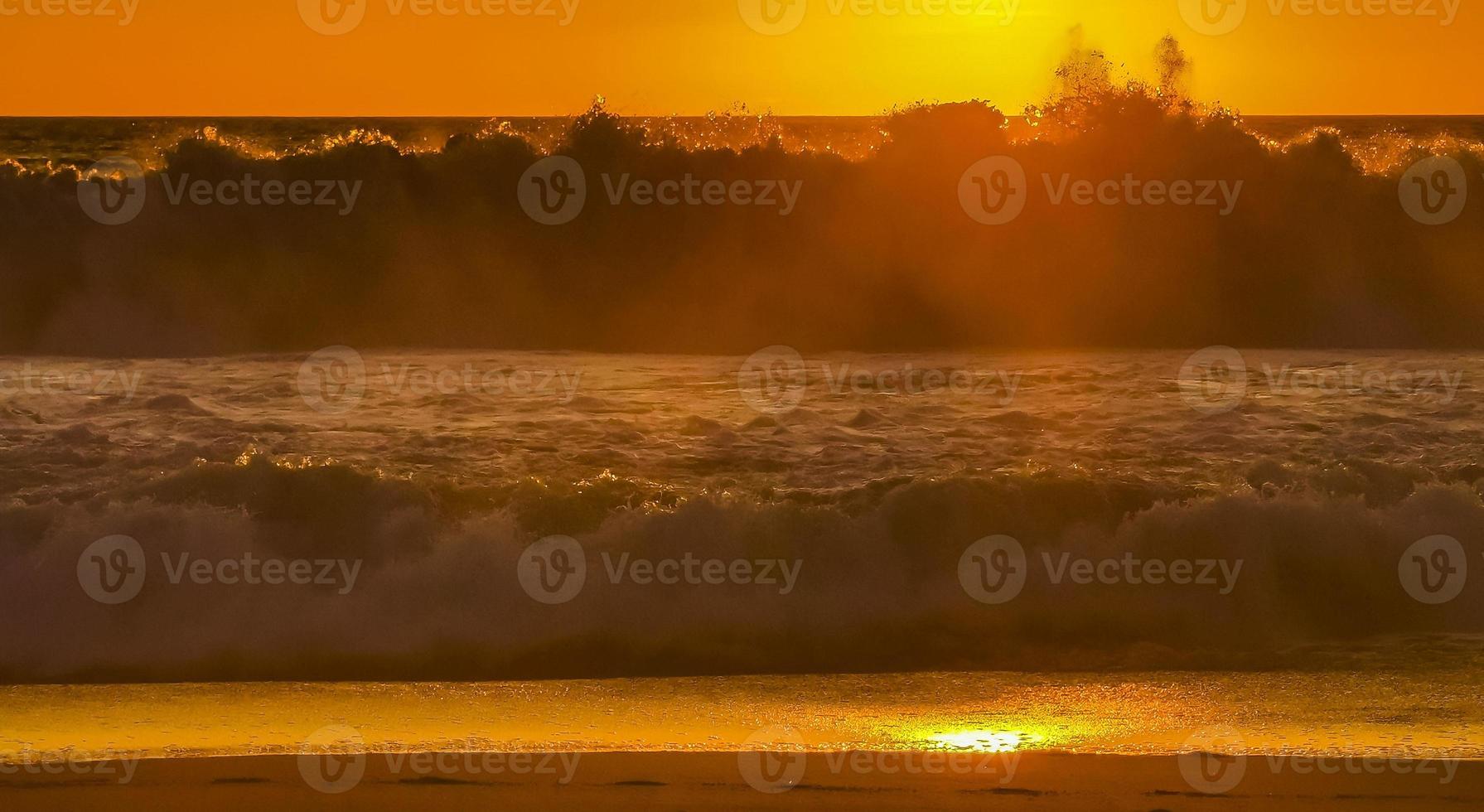 Colorful golden sunset big wave and beach Puerto Escondido Mexico. photo