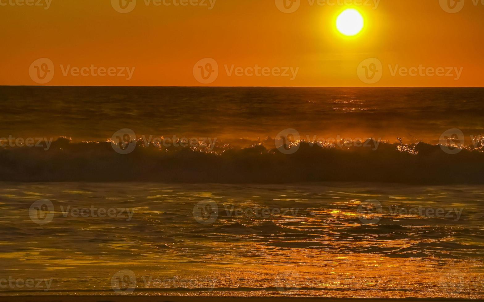 Colorful golden sunset big wave and beach Puerto Escondido Mexico. photo