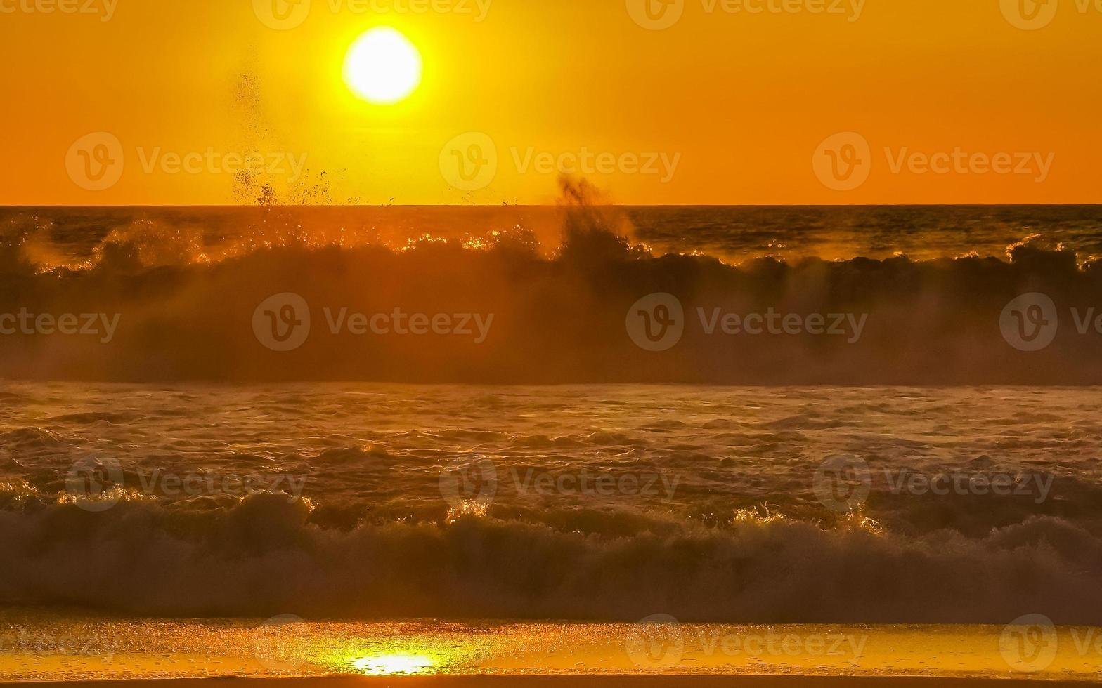 Colorful golden sunset big wave and beach Puerto Escondido Mexico. photo