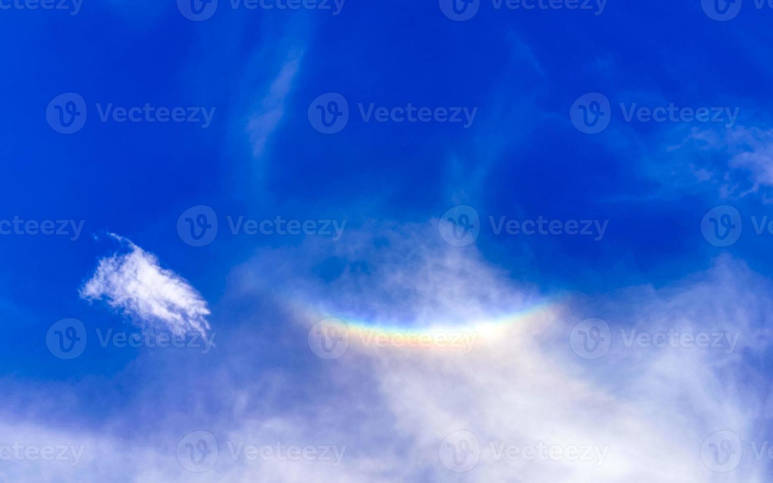 Beautiful and rare rainbow in cloudy sky blue background Mexico. photo