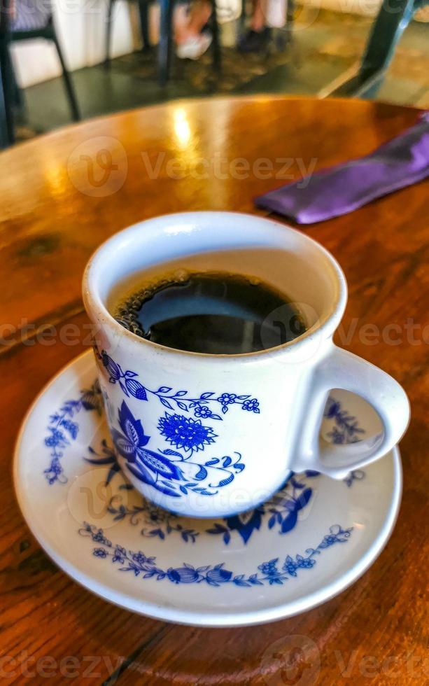 Blue white cup pot with black coffee wooden table Mexico. photo