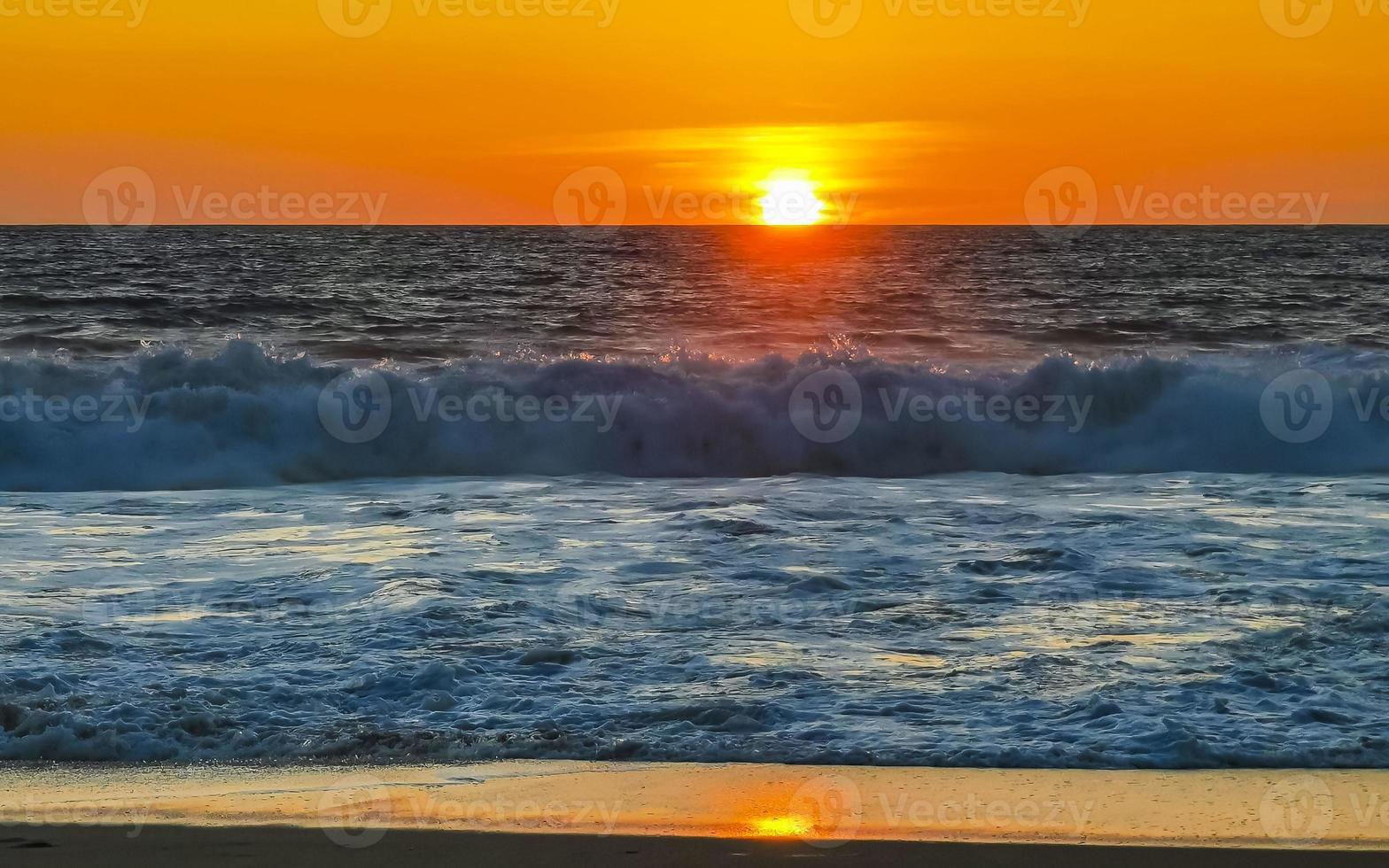 Colorful golden sunset big wave and beach Puerto Escondido Mexico. photo