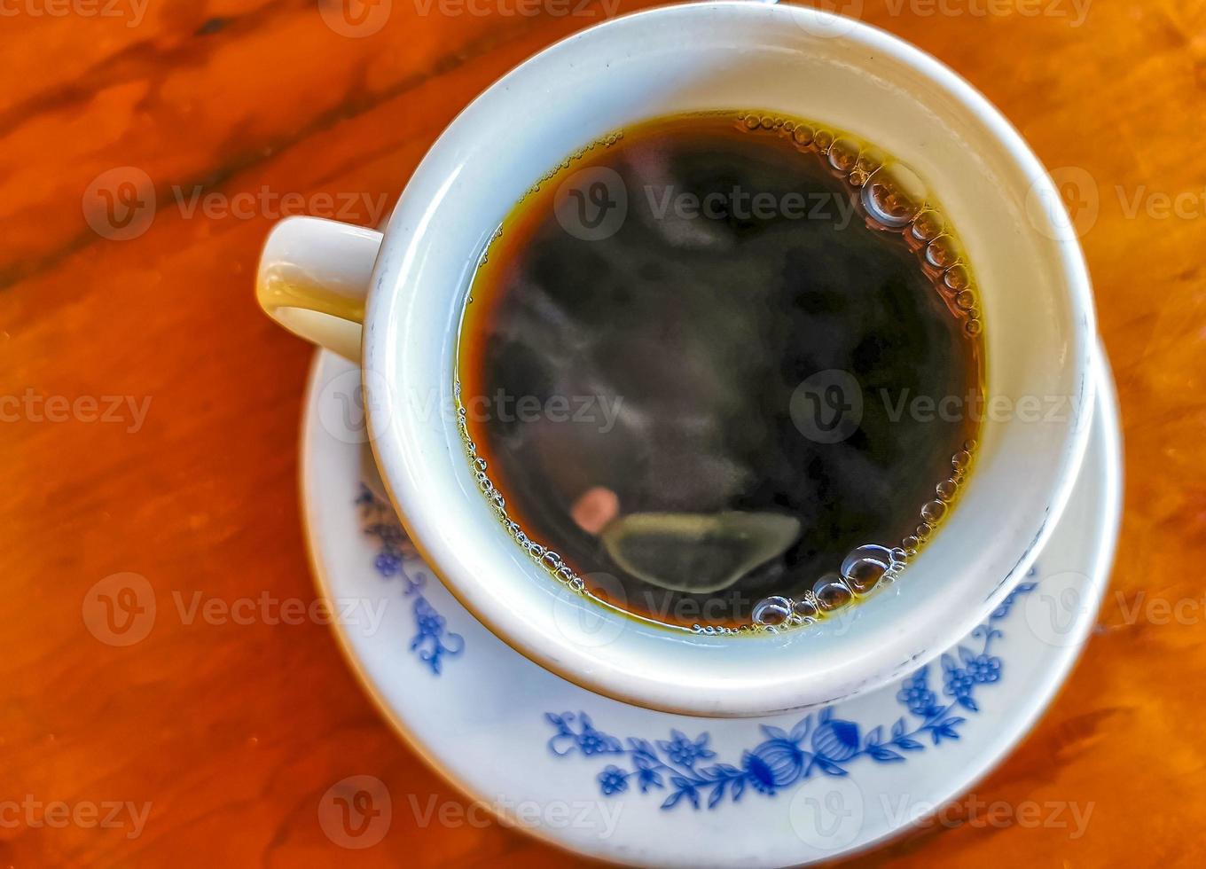 Blue white cup pot with black coffee wooden table Mexico. photo