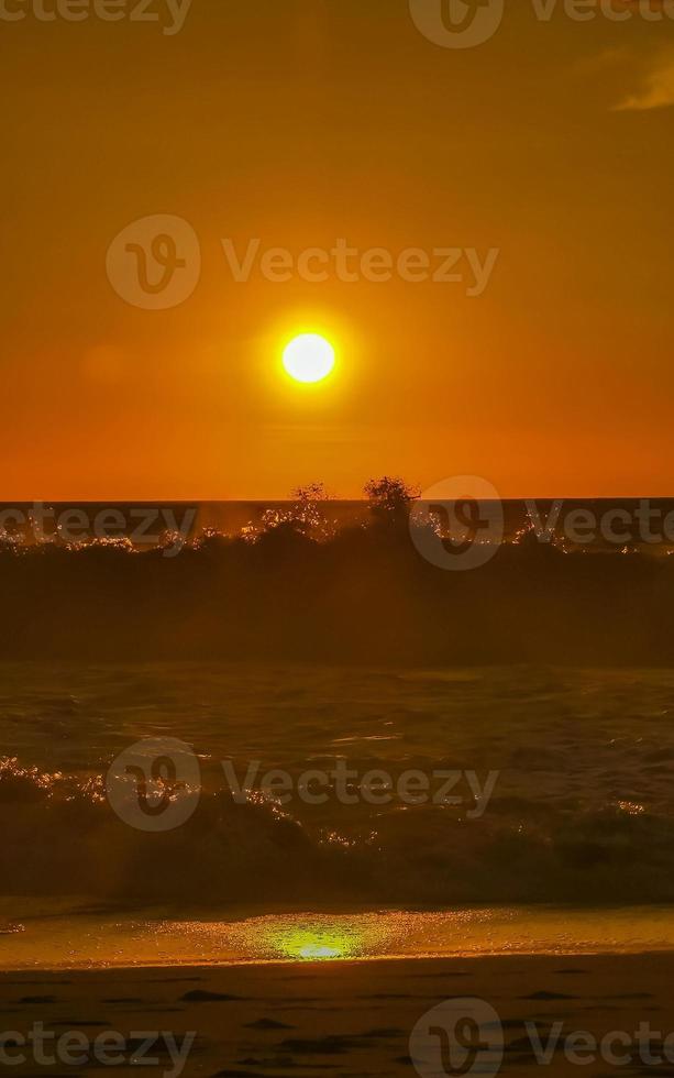 Colorful golden sunset big wave and beach Puerto Escondido Mexico. photo