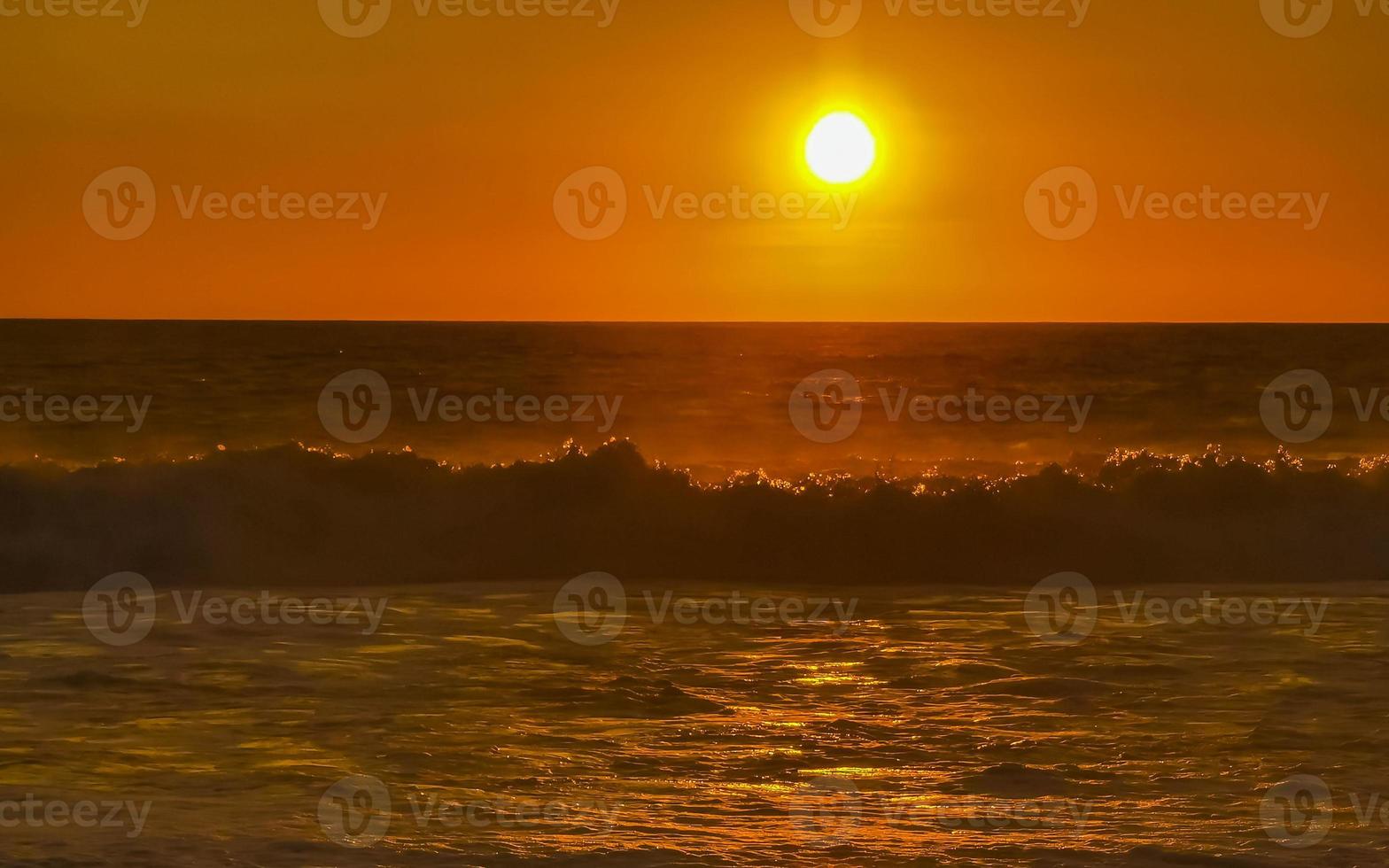 Colorful golden sunset big wave and beach Puerto Escondido Mexico. photo