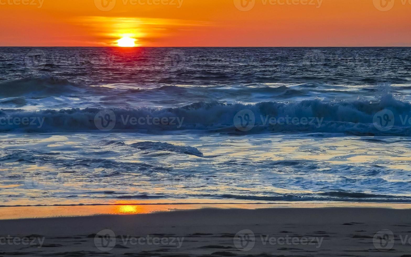 Colorful golden sunset big wave and beach Puerto Escondido Mexico. photo