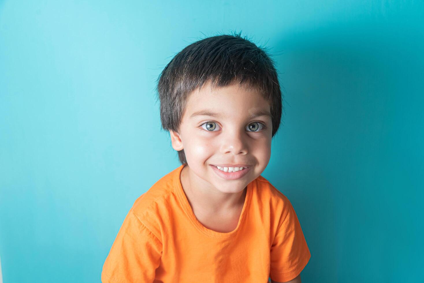 Boy in orange tshirt with funny face 13944481 Stock Photo at Vecteezy