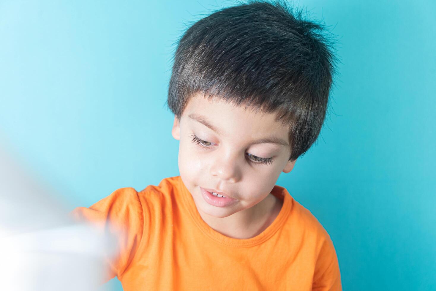 Boy in orange tshirt with funny face 13944491 Stock Photo at Vecteezy