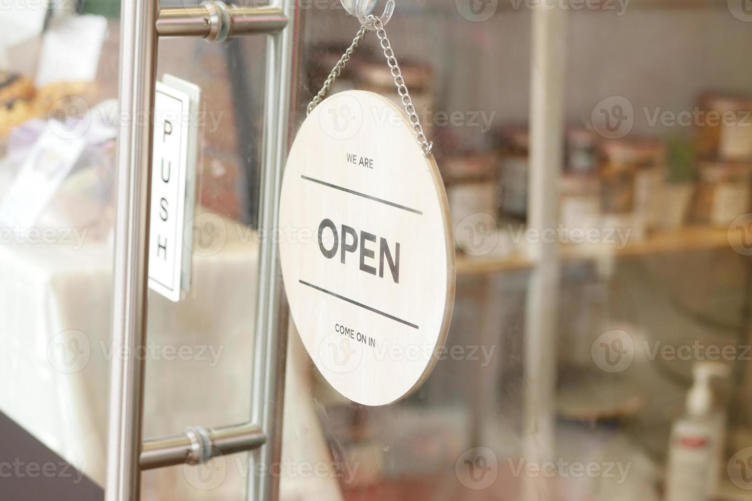 Open sign hanging front of cafe . photo