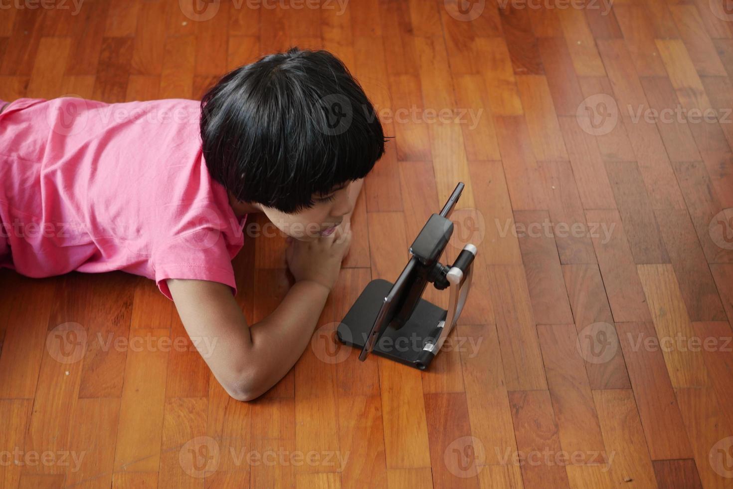 child hand pointing finger on digital tablet screen. photo