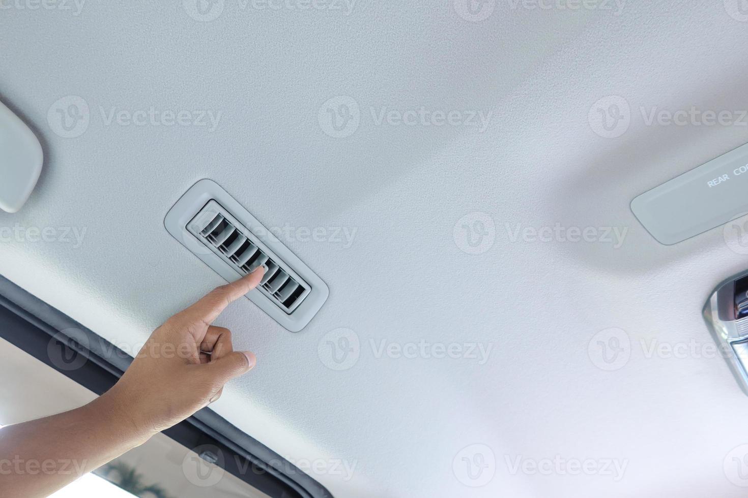 person hand adjusting car air conditioner photo