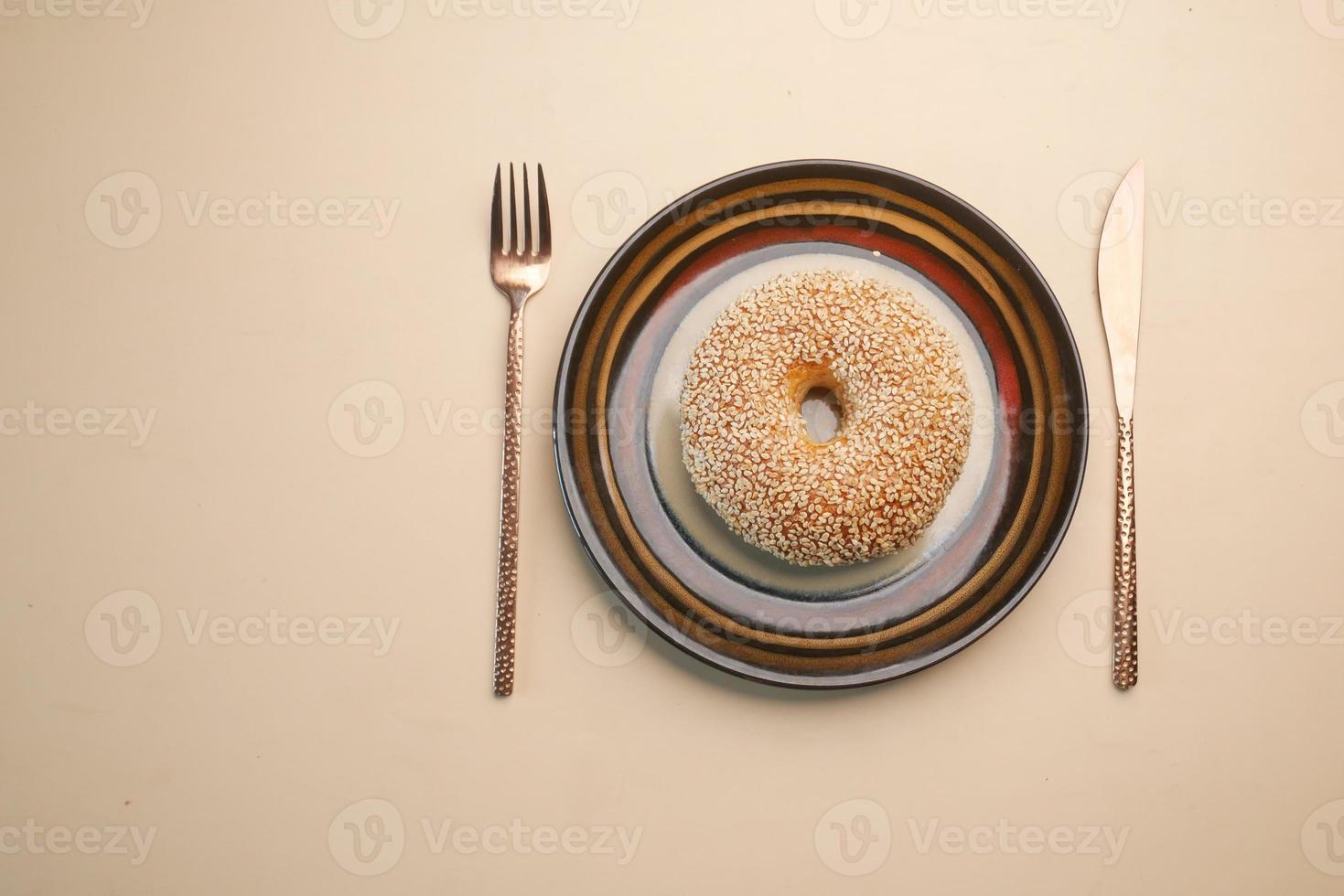 fresh bagel bread on a plate on table photo