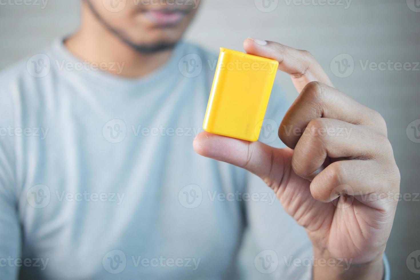 young man putting artificial sweetener in tea, photo