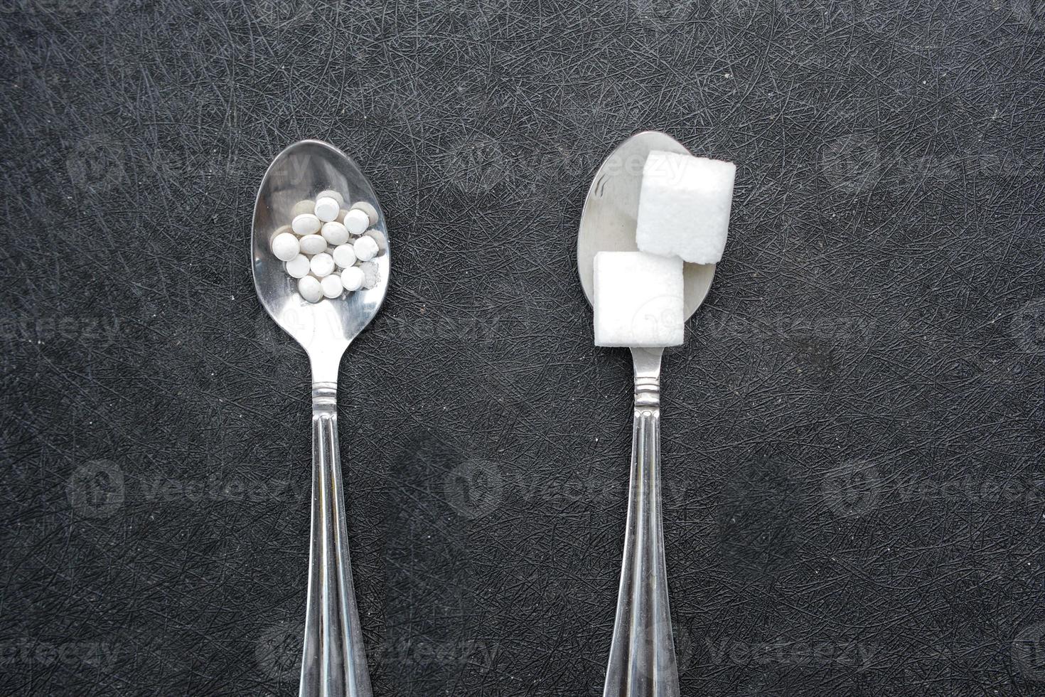 comparing artificial sweetener between raw sweet on a silver spoon photo