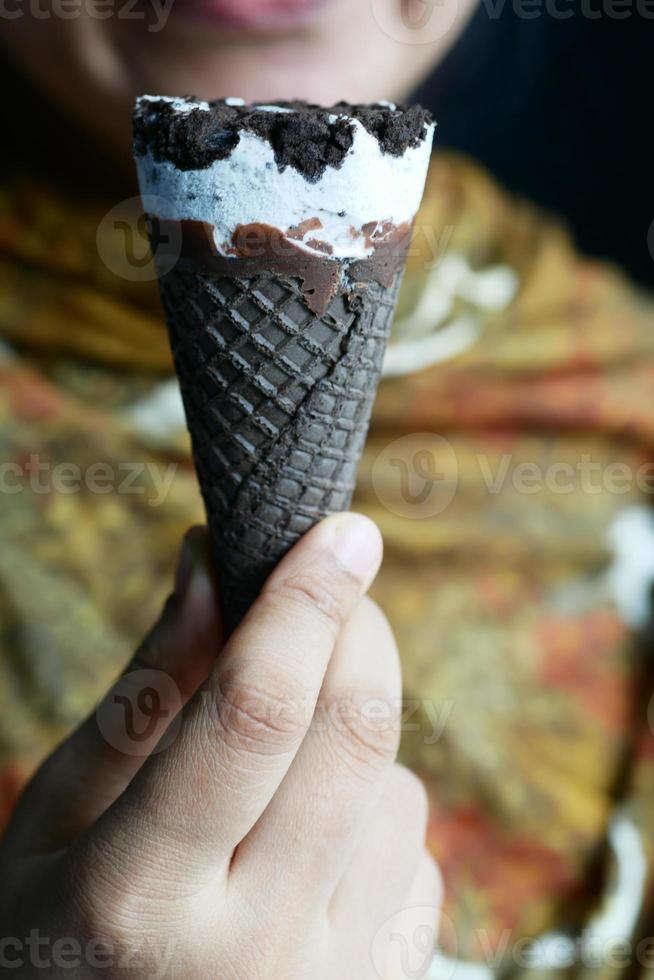 young women eating chocolate flavor ice cream photo