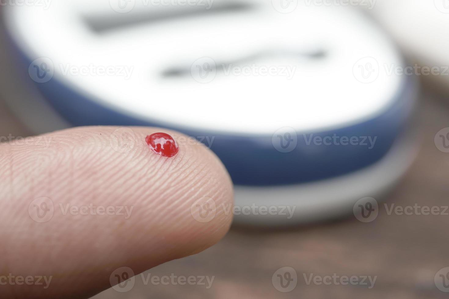 man's hand measuring blood sugar level photo