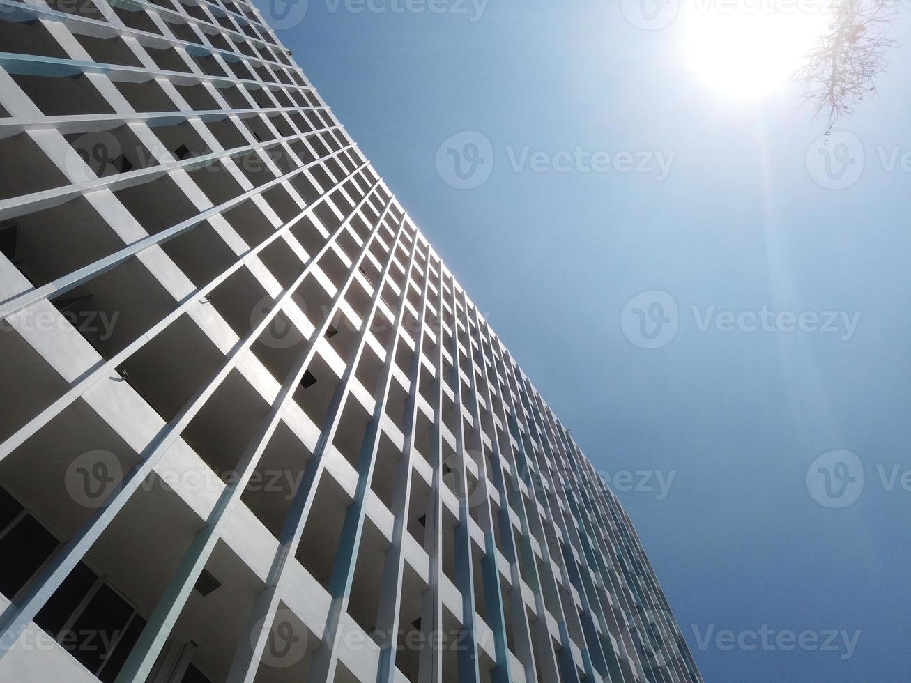 low angle view of singapore residential buildings against blue sky photo
