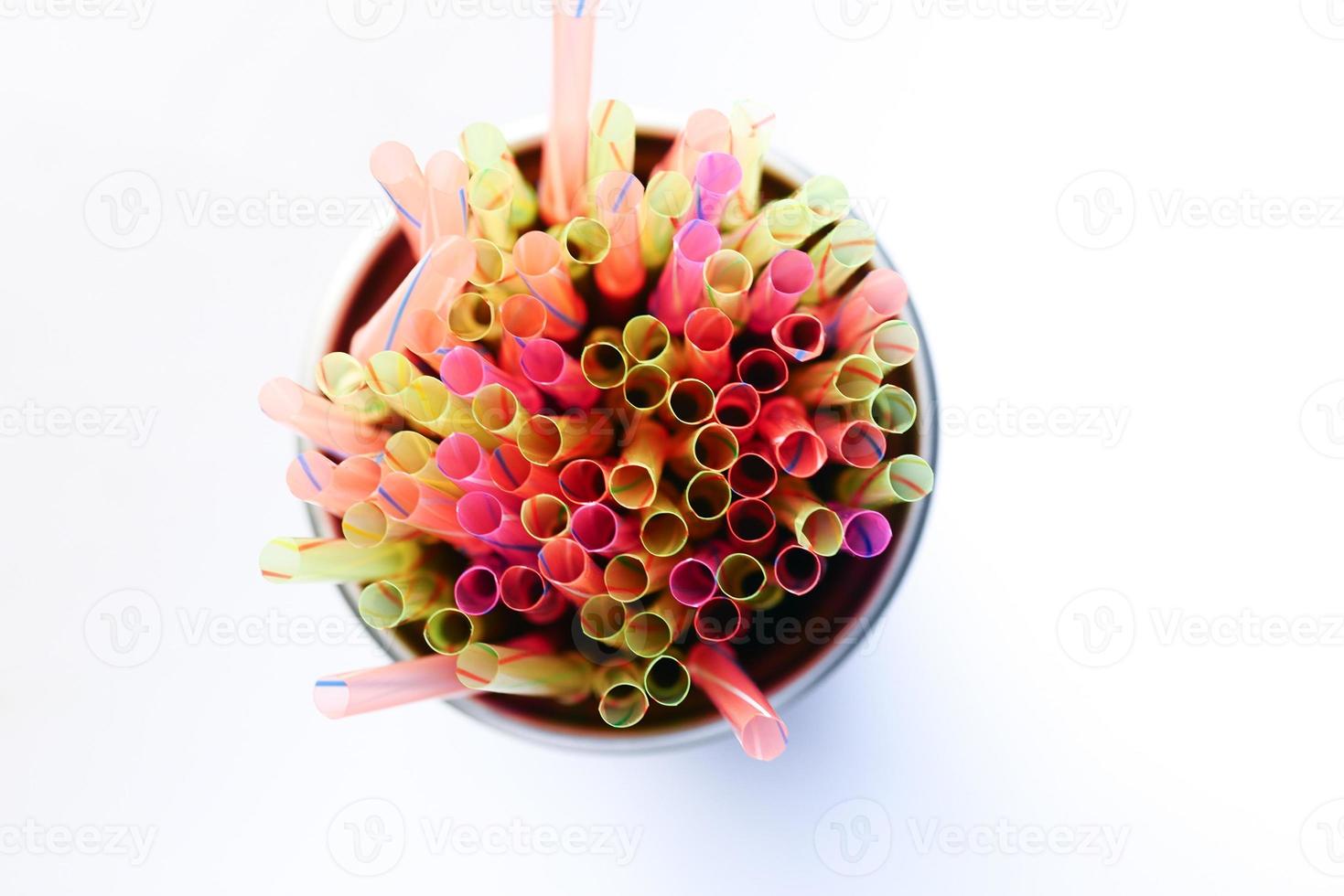 Colored striped bright plastic straws in a jar photo