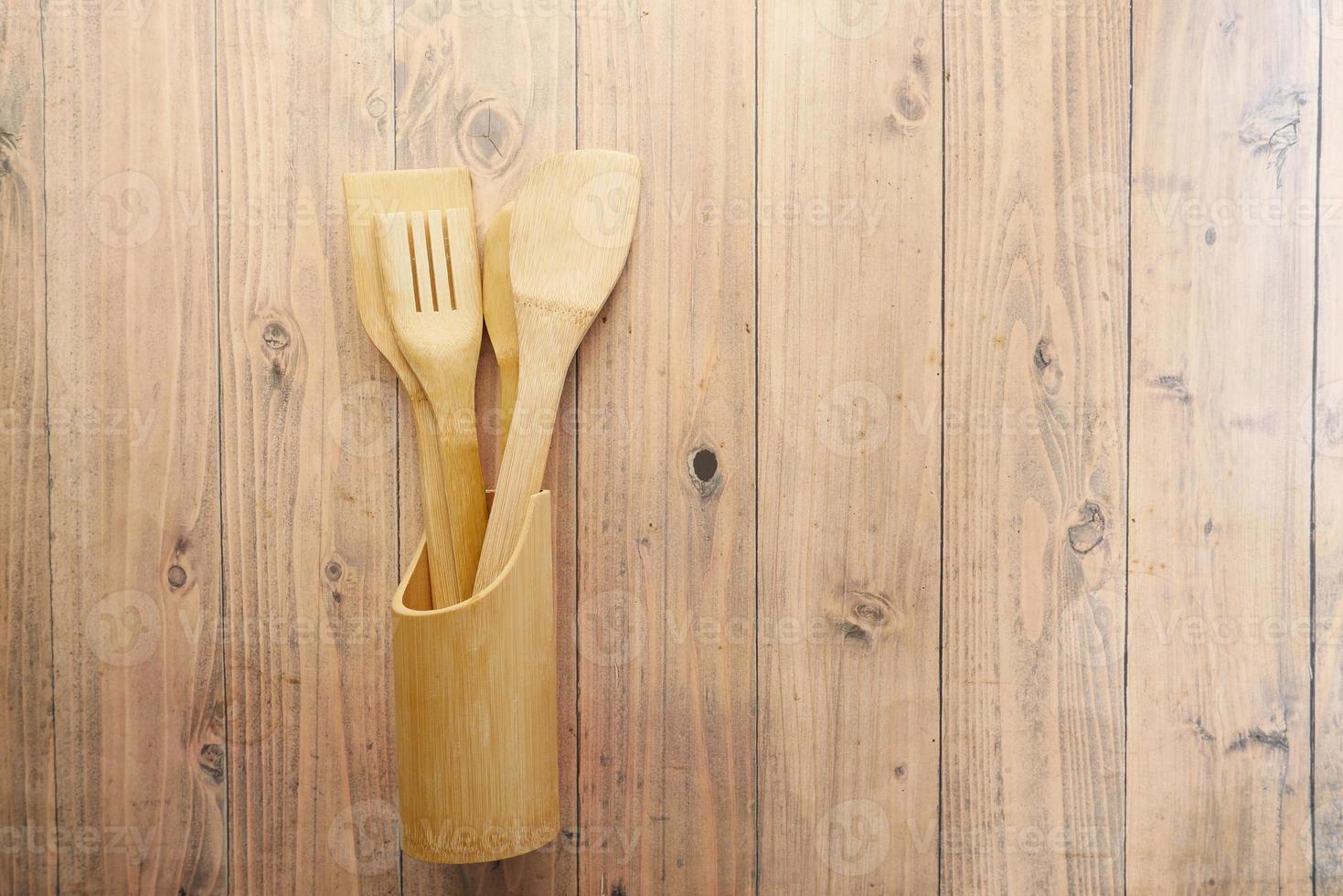 wooden cutlery fork and spoon on a chopping board on table photo