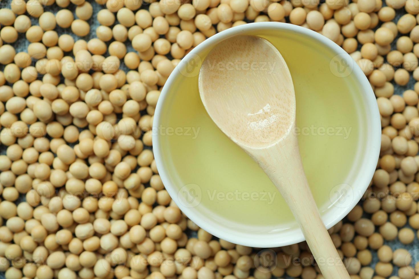 overhead view of Soy beans and oil on table photo