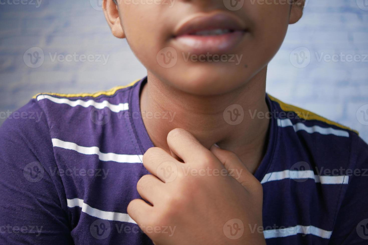 teenage boy suffering throat pain close up photo