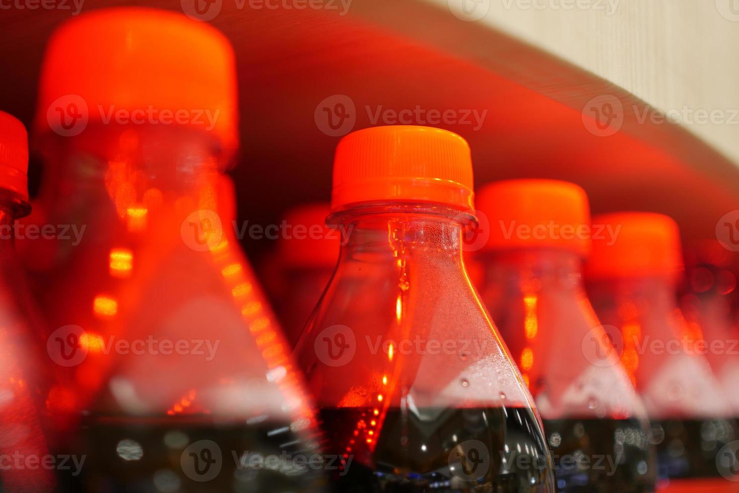 plastic bottles of soft drink on table photo