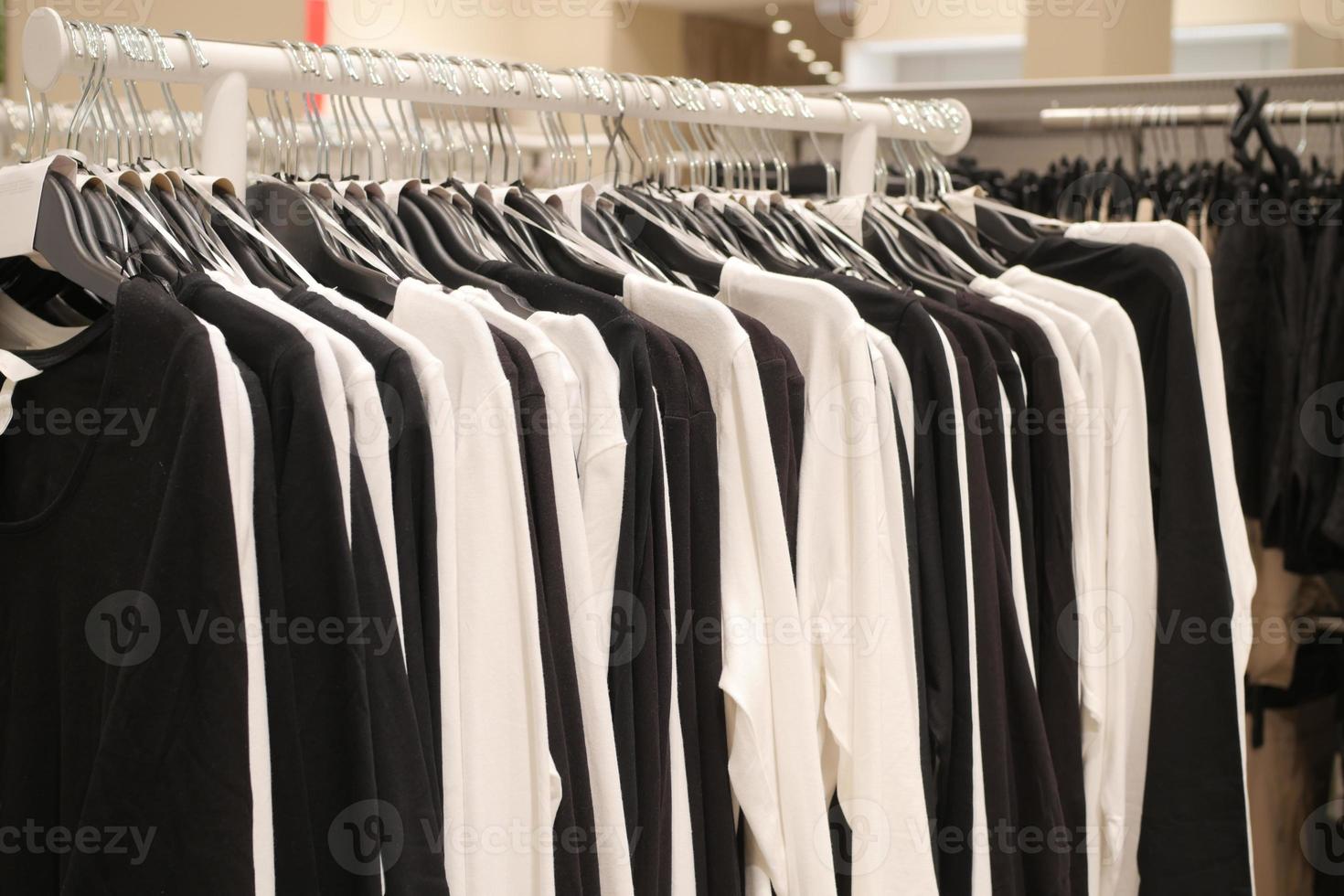 black and white women cloths hanging on shelf display for sale photo