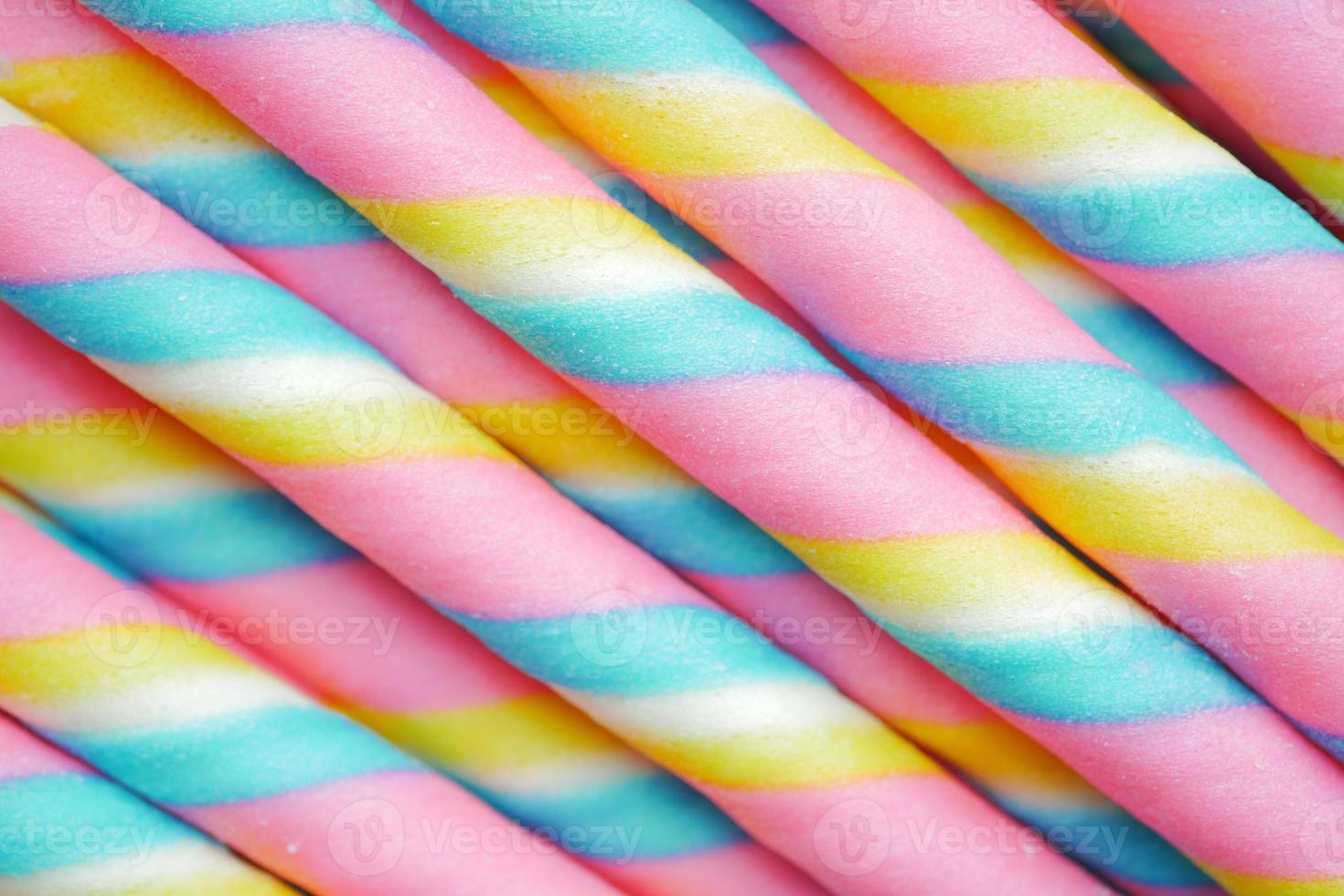 colorful wafer roll chocolate on pink background photo