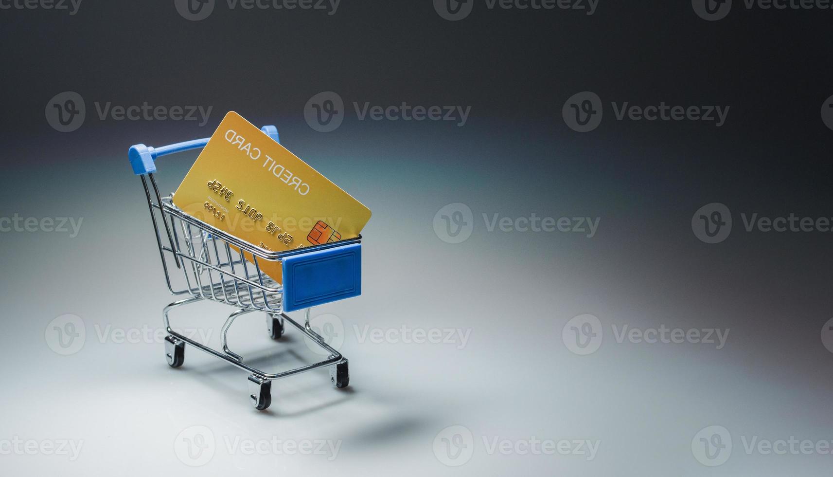 Shopping car and mockup credit card  on light and shadow background. shopping online concept. photo