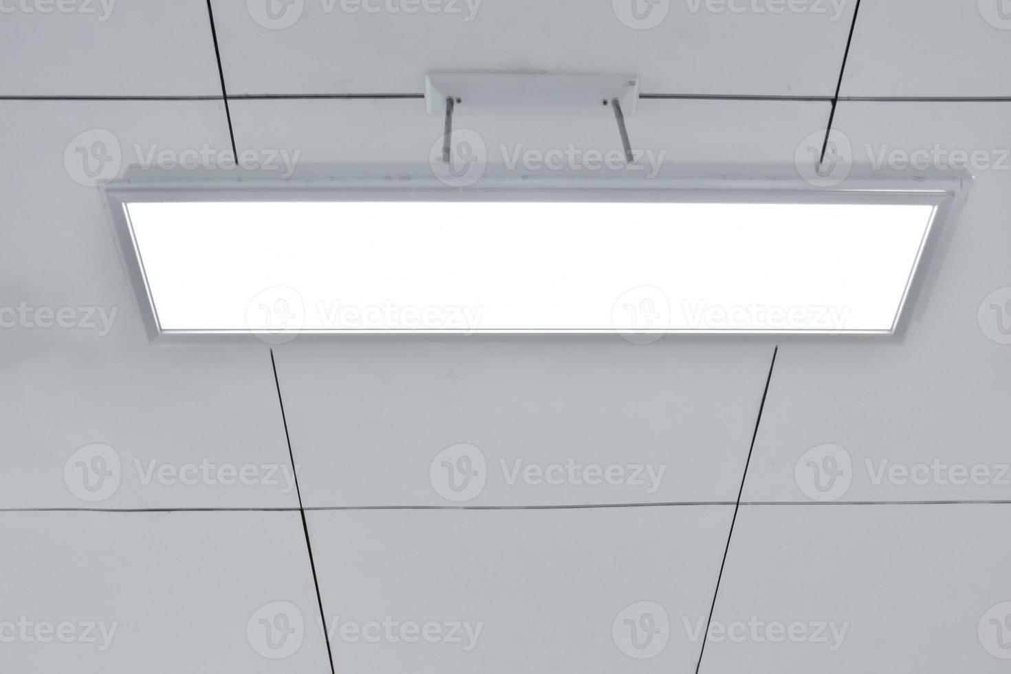 Ceiling lamp installed on the ceiling of the classroom, soft focus. photo