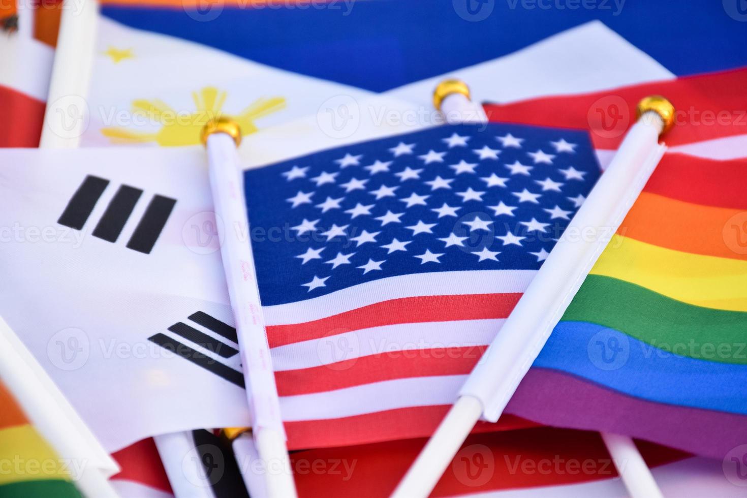 Rainbow flags and flags of many countries on floor, concept for celebration of lgbtq plus genders in pride month around the world, soft and selective focus. photo