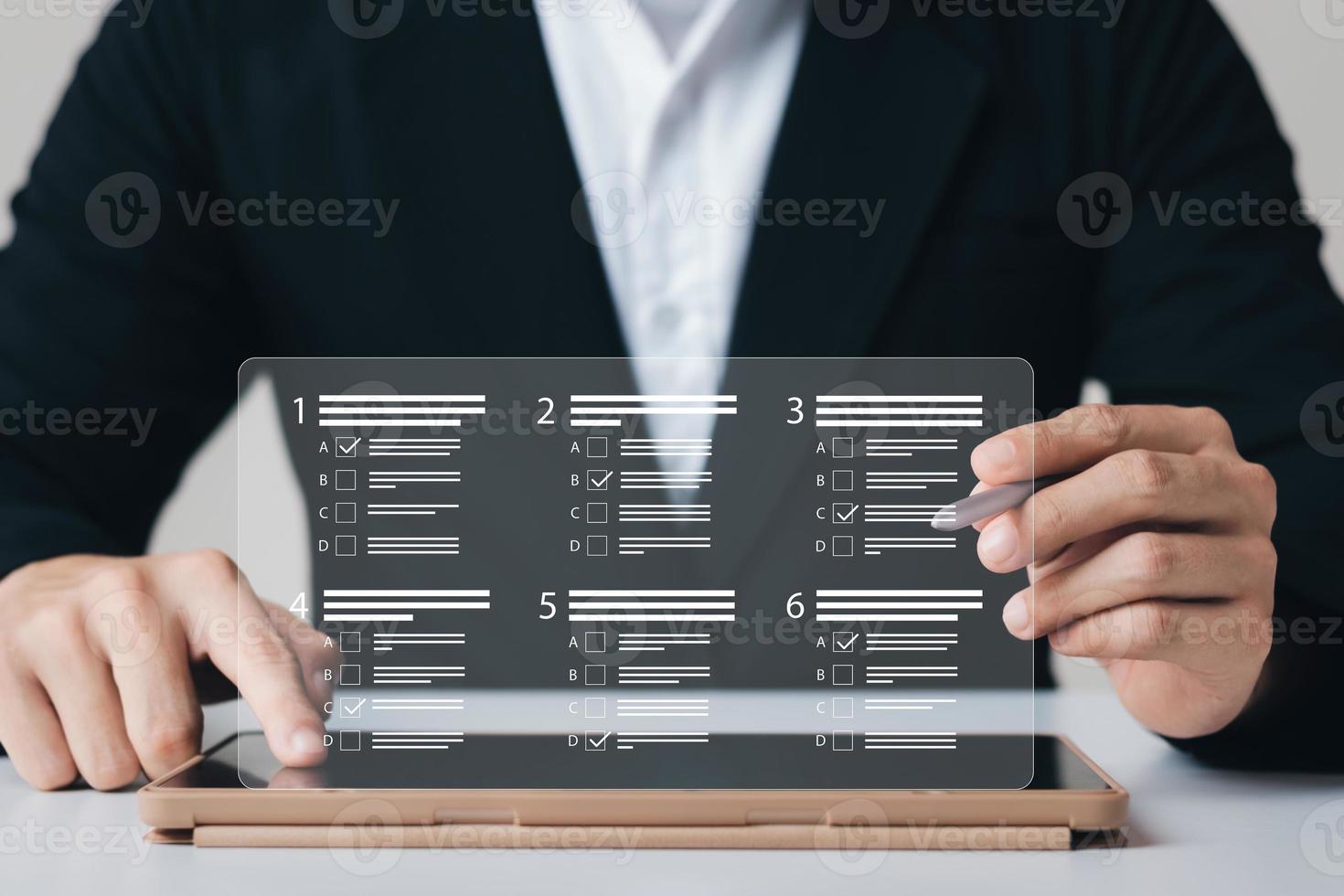 businessman using laptop to do online survey online exam Choosing the right answer in the exam, filling out an online survey form. Answer the test questions. photo